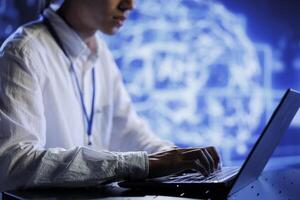 Computer scientist in data center uses artificial intelligence computing simulating human brain through self learning algorithms. System administrator with laptop working with AI deep neural networks photo