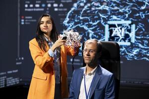 Company CEO using summit as platform to launch latest AI EEG headset product. Neuroscientist doing demonstration at forum in front of business leaders interested in artificial intelligence photo