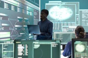 Governmental hacking specialist targeting sensitive information through high tech cyber attacks, digital espionage with a laptop and big screen. Hacker working on national security and data privacy. photo