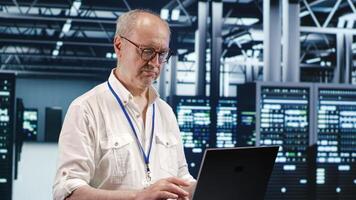 Adept repairman expertly managing data while navigating in industrial server room. Skillful employee ensuring optimal cybersecurity protection, optimizing systems and performing necessary updates photo