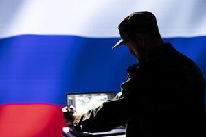 Russian Federal Security Service using radar system to detect ballistic missiles attacking borders. Kremlin regime army using notebook to scan approaching rockets, deploying shields photo