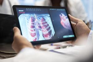 Doctors and nurses meet to discuss lungs radiography for patient care strategy in a treatment center. Medical team analyze organs x rays and healthcare records to focus on diagnostics. Close up. photo