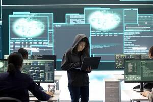Governmental hacker examines info on a big screen in agency office, using advanced technology to secure computer networks. Working on cyber security and defending against cyberwarfare. photo