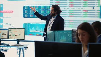 Teammates and manager assembling in a big data room to go over their results, examining graphic representations with feedback from shareholders investors. Exchanging perspectives. Camera A. photo