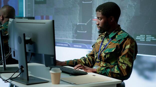 Military personnel in a control center working on data processing, integrating real time surveillance and security protocols essential for national defense and strategic operations. Camera A. photo