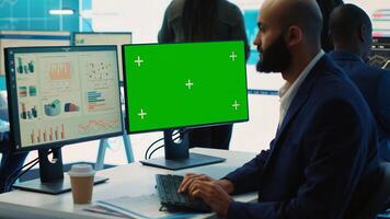 Chief financial officer reviews cost and revenue numbers next to a greenscreen, working on data management study for future improvement. Accountant ensures organizational success. Camera A. photo