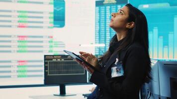Marketing manager evaluating sales and profit within infographics data, comparing reports on a big screen. Team leader planning promotional activities for a better public image, PR tasks. Camera A. photo