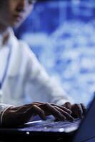 IT consultant uses device for artificial intelligence computing simulating human brain through self learning algorithms, close up. Admin working with AI deep neural networks, blurry background photo
