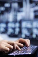 Profficient employee in data center providing dedicated VPN servers able to deliver improved privacy, encrypted sensitive data, online anonymity and secure internet connections to users, close up photo