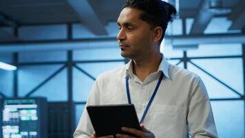 Security analyst in data center monitoring security threats, implementing cybersecurity measures. Expert ensuring compliance with regulations to protect data center assets, camera A photo