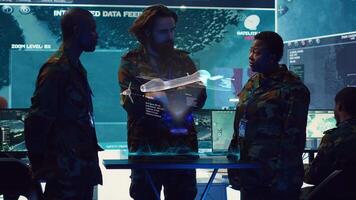 Air defense operators evaluating incoming enemy aerial attacks using augmented reality holograms. Counterintelligence division agents maintains air space superiority with AR radar technology photo