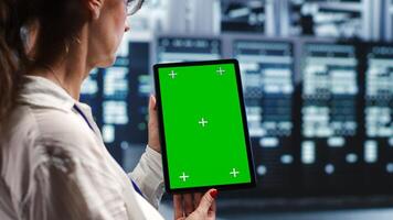 Octogenarian specialist in servers workspace housing high end processors capable of quickly and efficiently performing complex computations and data analysis, using mockup tablet to recondition rigs photo