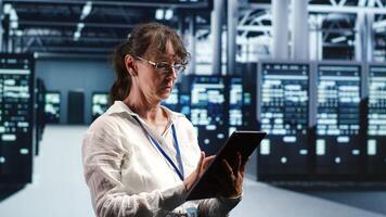 Old engineer working in data center housing GPU dedicated servers that can process artificial intelligence tasks with high efficiency. Qualified expert fixing broken hardware used for machine learning photo
