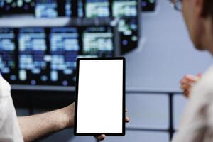 Close up of mock up tablet used by hardworking team in cloud computing business server hub delivering massive computational power, capable of processing and storing vast amounts of datasets photo