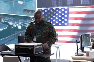 Military specialists in a control center monitor global security operations, manage surveillance systems and protect classified data using advanced technology to ensure national defense. photo