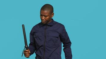 Security guard tasked with restricting unwanted access looking to sky, praying. Portrait of bodyguard waiting for miracle, doing spreading arms gesture, studio background, camera A photo