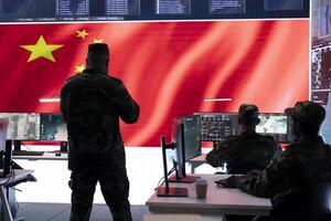 Military analyst reviews surveillance data on computer and big screen in Chinese military command post, spreading misinformation and inflicting fear among the population. Defense and security. photo