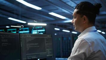 Data center system administrator responsible for installation of networking equipment solving tasks. IT employee at work doing maintenance on server room hardware, camera B photo