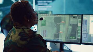 Female army operator registers important information from military surveillance system, working in control room base of operations to gather intelligence for the troops. National safety. Camera A. photo