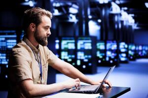 Focused repairman evaluating data center rigs helping enterprises manage databases and store files. Professional inspecting server rows infrastructure used for high performance computing photo