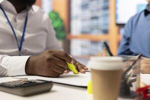 Financial expert highlighting contract terms to explain to old clients in modern office, helping senior people with professional advice. Choosing a retirement plan option. Close up. photo