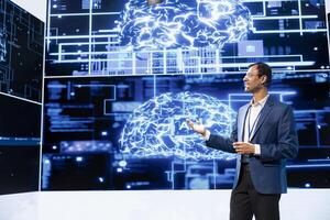 Cheerful presenter speaking at tech conference, exploring latest AI technology trends and case studies. Upbeat IT professional presenting how artificial intelligence is shaping future during event photo
