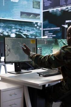 In a high tech control tower, experts team examining real time data collected by cctv satellite system. Crew gathering intelligence to support military operations for national defense. photo
