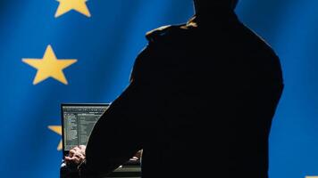 EU alliance engineer protecting against fake accounts on social media promoting totalitarian governments interests. Technician working for European Union doing cybersecurity job, camera A photo