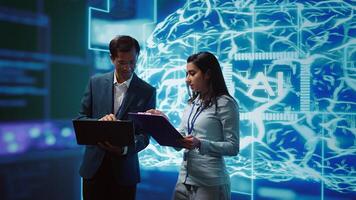 AI researcher and coworker working with artificial intelligence neural networks. Computer scientists collaborating on developing AI system in high tech workspace, camera B photo