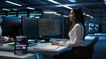 Technician in data center provides technical support to users, troubleshooting issues, close up. Server hub workers carrying out operational technical interventions requested by clients, camera B photo