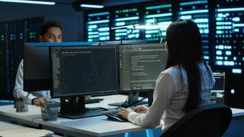 Engineer using augmented reality tech in data center, installing software, troubleshooting issues. IT expert in server hub looks at AR hologram, establishing performance benchmarks, camera A photo