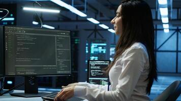 Programmer in data center arriving in office, being tasked with ensuring system can handle networking tasks. IT specialist in server farm starting job shift, tracking network traffic with PC, camera A photo