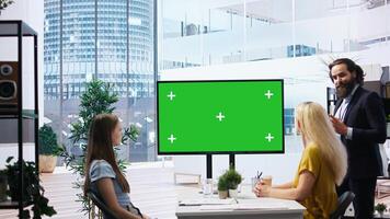 Financial adviser conducting audit of clients income, doing presentation on green screen to help them build saving habits. Agent using large mockup display to show investing tips, camera A photo