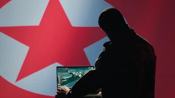 North Korean spy in control room uses military tech to identify threats during border conflict. Pyongyang regime intelligence agency operator uses software to relay info to war front lines, camera A photo