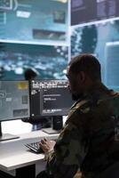 Army intelligence expert utilizes modern computer systems and satellite radar imagery to enhance national security, support strategic initiatives and ensure defense in a mission control center. photo