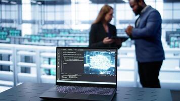 Laptop in data center establishment with artificial intelligence computing simulating human brain. Close up shot of notebook displaying AI machine learning algorithms, camera B photo