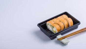 slice of sushi roll in bento box with white background. isolated. photo