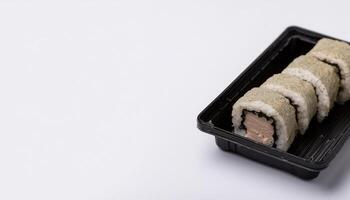 slice of sushi roll in bento box with white background. isolated. photo