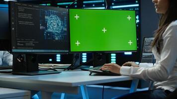 Admin using AI tech on isolated screen PC to do maintenance in server room. Specialist in data center using artificial intelligence on chroma key to process datasets for training, camera A photo