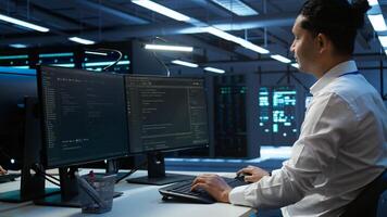 Engineer overseeing data center, making routine improvements and updates to ensure system can handle all networking tasks. Server room employee tracking network traffic and activity, camera B photo
