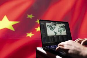 Chinese army conducts tactical reconnaissance, utilizing laptop for data analysis and mission planning, close up. CCP government military agent looks at aerial map on screen, pinpointing targets photo