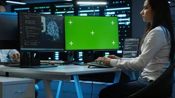 Technician doing checkup on green screen server hub PC to optimize it for data processing requirements of AI. Worker inspects data center used for machine learning using mockup computer, camera A photo