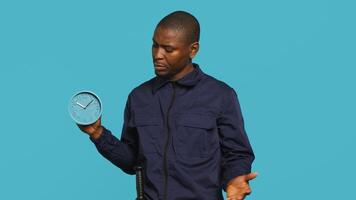 Security guard in uniform feeling amazed while at work, saying wow. Portrait of awestruck bodyguard being astonished during protection job shift, studio background, camera A photo
