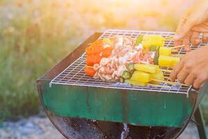 Blurred image,Barbecue BBQ skewered on a charcoal grill is a street food that is convenient for a party or picnic and barbecue BBQ is also increasing its popularity in many countries. photo