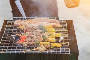 Blurred image,Barbecue BBQ skewered on a charcoal grill is a street food that is convenient for a party or picnic and barbecue BBQ is also increasing its popularity in many countries. photo