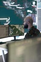 Anti terrorism division controlling air and sea traffic activity around the national territory, ensuring protection from military base of operations. Army engineer operates radar surveillance. photo