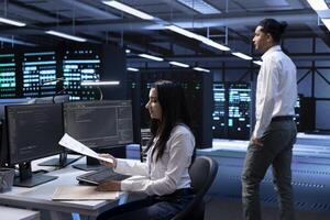 IT manager maintaining accurate documentation of data center hardware, configurations, and procedures. Server farm worker establishing performance benchmarks and conducting analysis photo