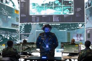Army officer analyzing surveillance data on a hologram projection, reviewing registered information from satellite surveillance system. Looking at new defense operation details in power base. photo