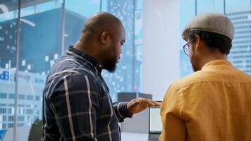 Corporate clients evaluating an investment opportunity in real estate, reviewing architectural blueprints and discussing the best strategies for office relocation and creative development. Camera A. photo