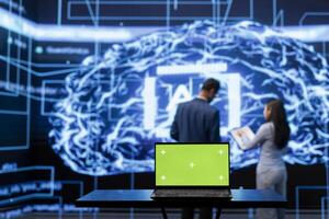 AI engineers using isolated screen device for business data analysis. IT department staff members work on chroma key notebook to automatize tasks using artificial intelligence photo